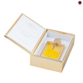 Perfume bottle in a gold box with a white interior